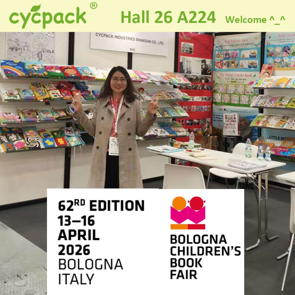 A booth at the Bologna Children's Book Fair featuring a smiling woman in a beige coat, surrounded by colorful children's books on display.